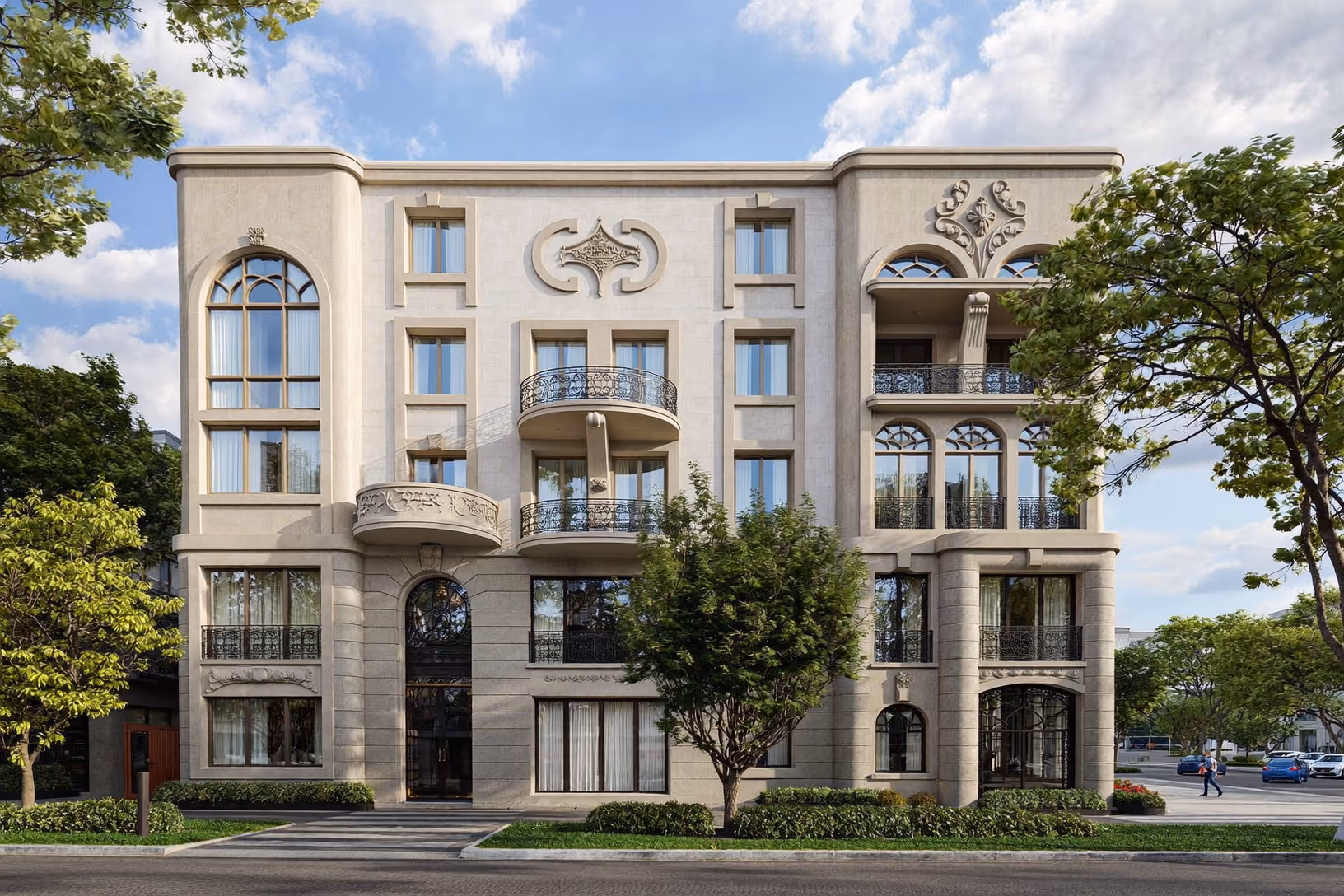 Façade d'un immeuble résidentiel de trois étages en enduit beige crème, avec fenêtres cintrées, balcons en fer forgé, ornements sculptés et arbres urbains au premier plan.